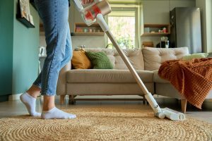 Senior downsizing cleaning tips image of vaccuuming.