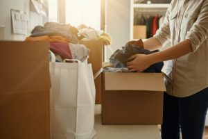 photo of packing clothes and items for moving to senior living